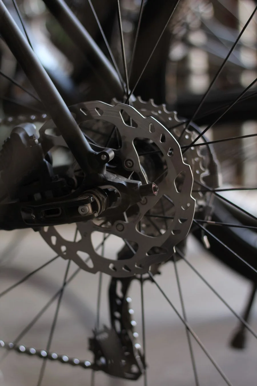 Close view of a bicycle disc brake rotor, wheel hub and spokes